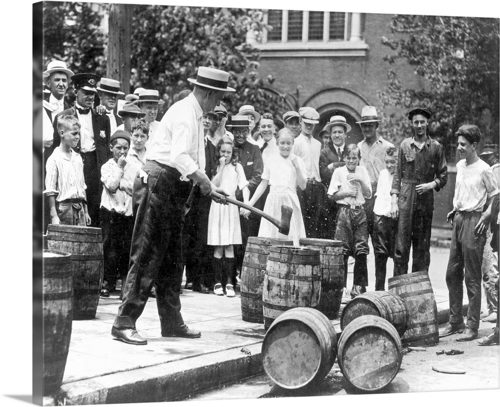 Federal agent destroying contraband kegs of alcohol in Chicago during the 1920s.