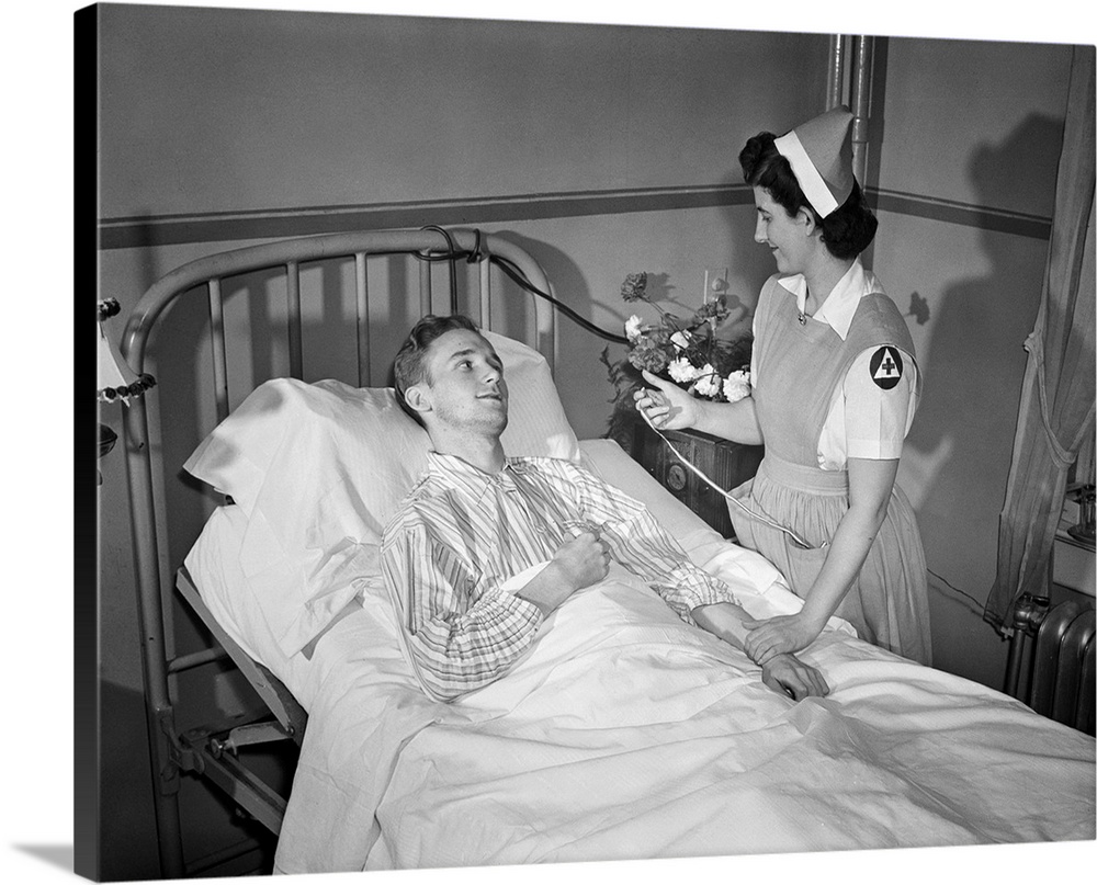 A Red Cross nurses' aide taking a patients' pulse at a hospital in Washington, D.C., 1942.