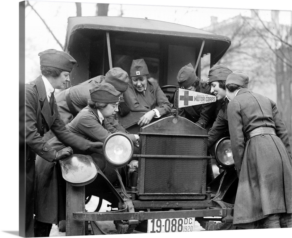 Members of the American Red Cross Motor Corps learning to fix an automobile engine, c1920.