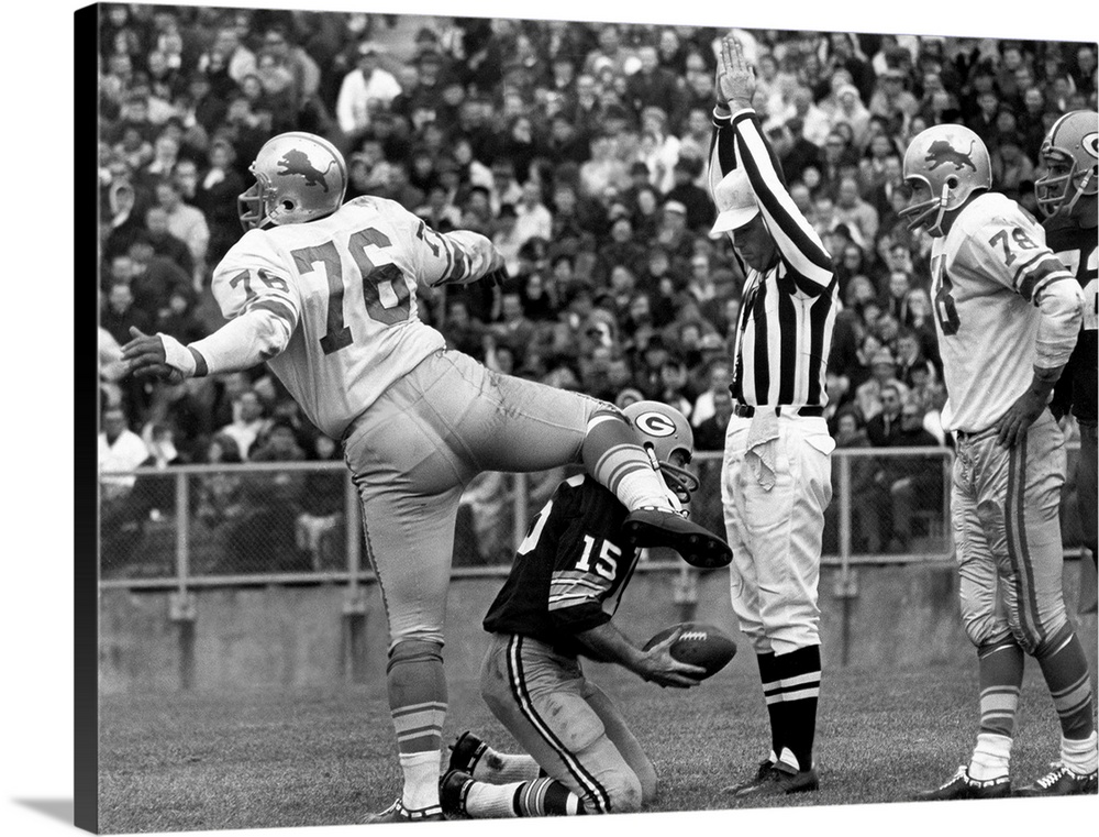 Defensive tackle Roger Brown of the Detroit Lions exults after sacking quarterback Bart Starr of the Green Bay Packers (kn...