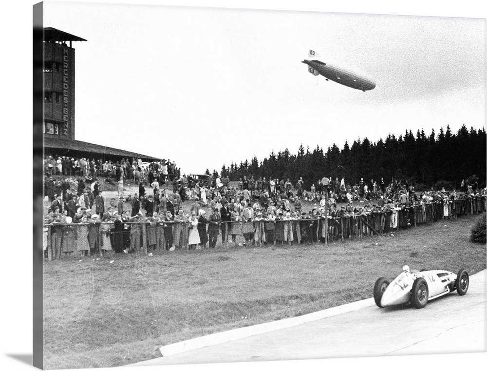 (1901-1958). German racing driver. The airship Graf Zeppelin hovers above the crowd at Nuremberg, Germany, as Caracciola w...