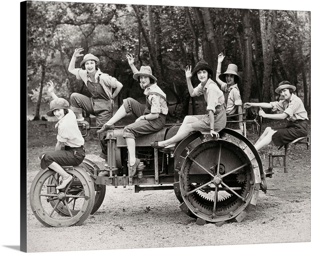 A group of women posing on a tractor in rural America. Photograph, c1925.