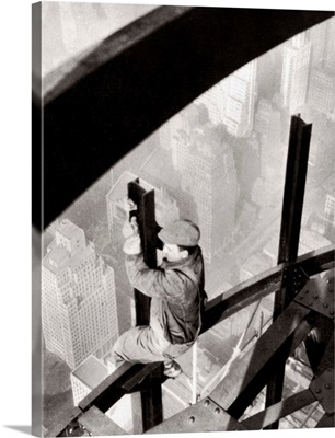 Steelworker atop the Empire State Building, New York City, during its construction, 1931