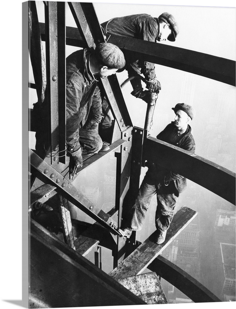 Steelworkers on girders of the Empire State Building, New York City. Photographed by Lewis Hine, 1931.