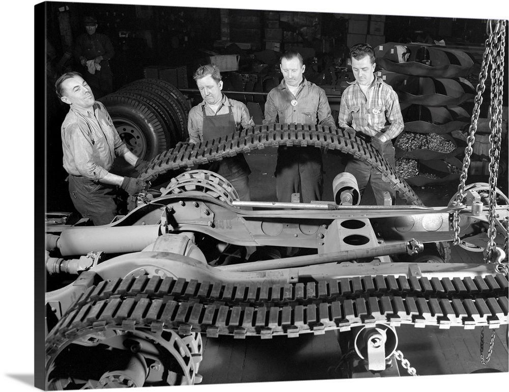Factory crew at the White Motor Company in Cleveland, Ohio, mounting a tractor belt on a half-track military vehicle for t...