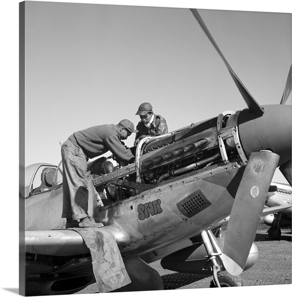 Tuskegee Airmen mechanics Marcellus Smith (left) and Roscoe Brown, working on a fighter plane at Ramitelli Airfield, Italy...