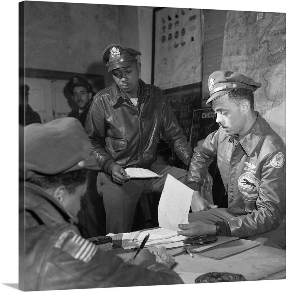 Tuskegee Airmen Woodrow Crockett (standing) with Group Operations Officer Edward Gleed at Ramitelli Airfield in Italy. Pho...