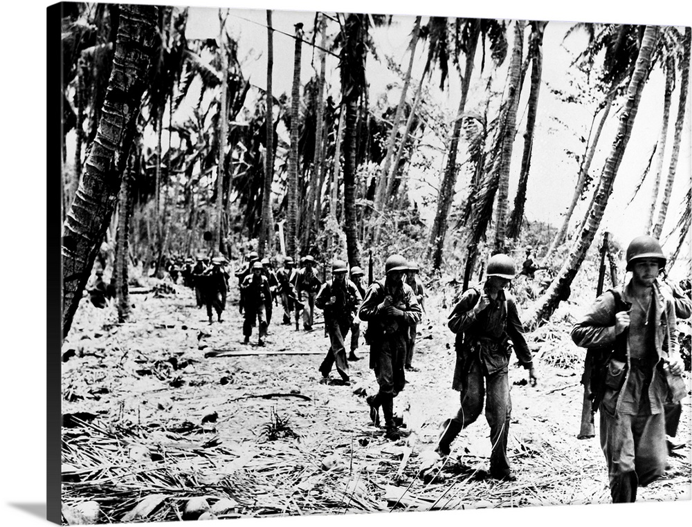 U.S. Marines advance into the village of Matanikou during the Battle of Guadalcanal, Solomon Islands, 24 December 1942.