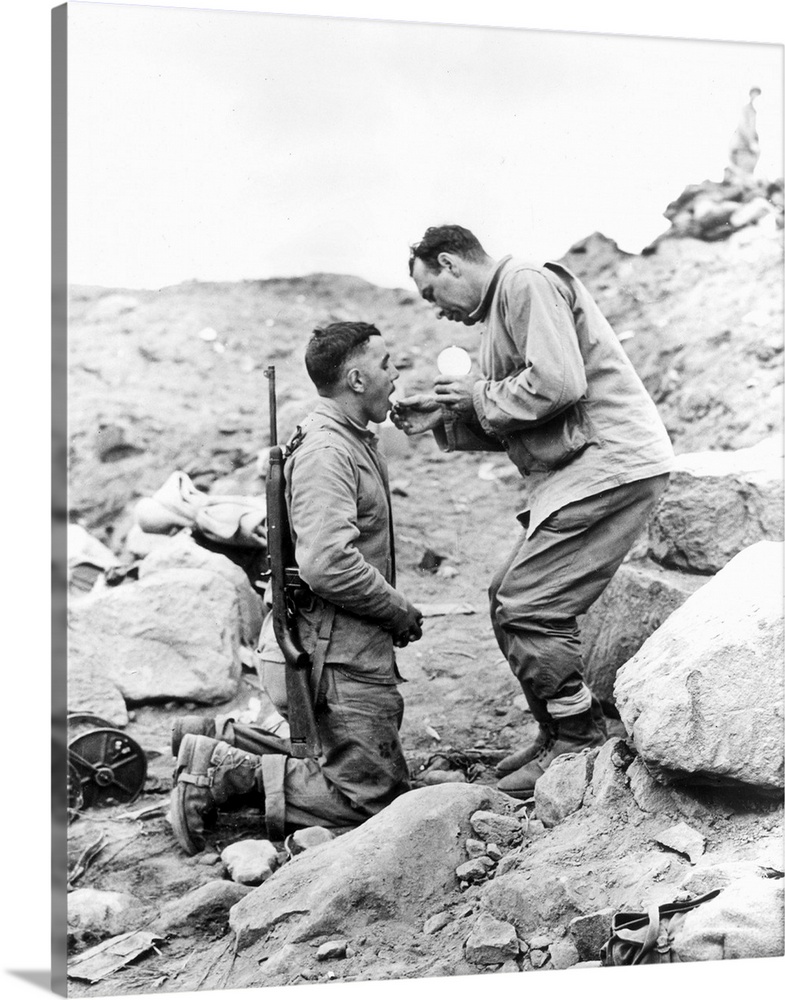 An United States Marine receiving Communion on Iwo Jima, 1945.