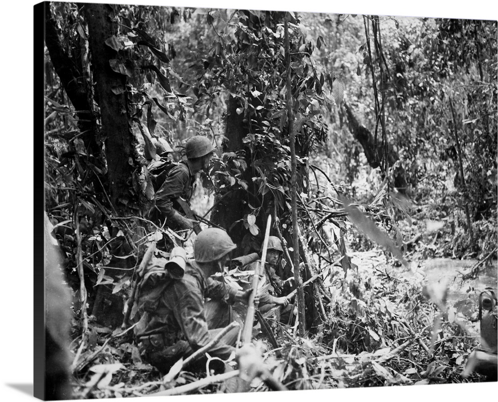 U.S. Marines wait for a tank to advance during the drive to capture the Japanese airstrip at Cape Gloucester, island of Ne...