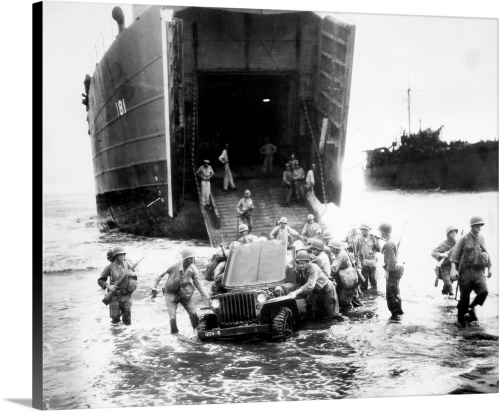 A stalled jeep is pushed ashore by U.S. infantrymen during the invasion of Wake Island, Dutch New Guinea, during World War...