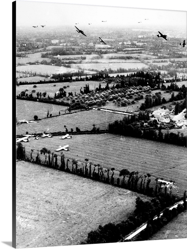 Gliders of the U.S. Ninth Air Force land in Normandy, France, during the D-Day invasion, 6 June 1944. Some gliders have al...