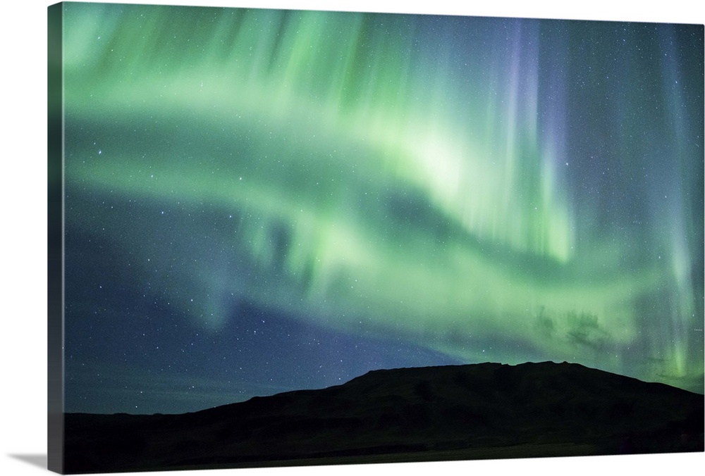 Vivid green and blue Northern Lights in the sky above the South Coast of Iceland.