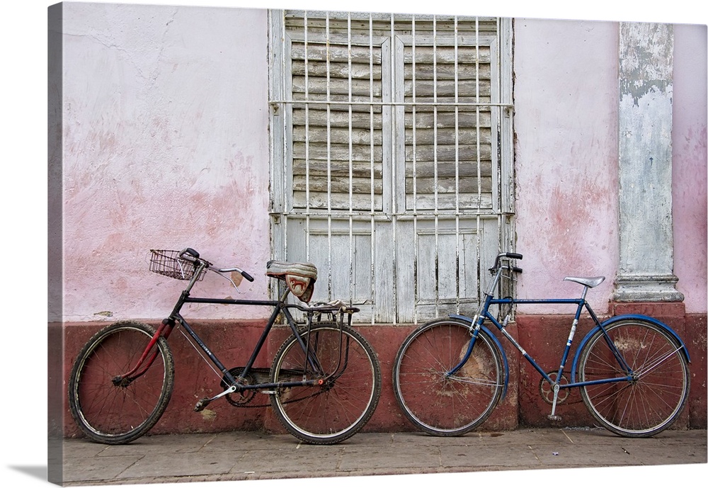 Two bicycles leaning against a weathered wall in Havana, Cuba.