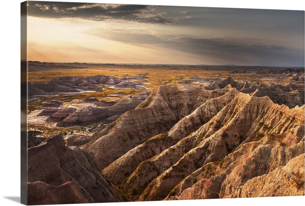 Beams of sunlight shining on the rugged landscape of the South Dakota Badlands in the morning.