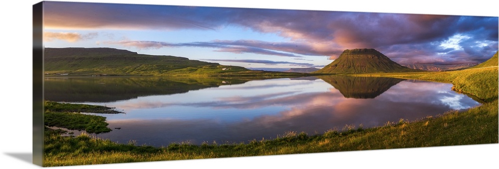 Panoramic view of Mount Kirkjufell and the lake below at sunset, Iceland.