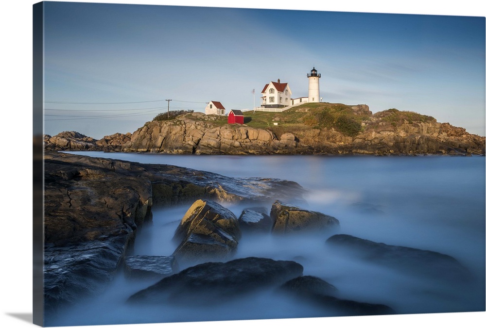 Nubble Lighthouse in Cape Neddick, Maine, on a rocky outcropping in the ocean on the rugged coast.