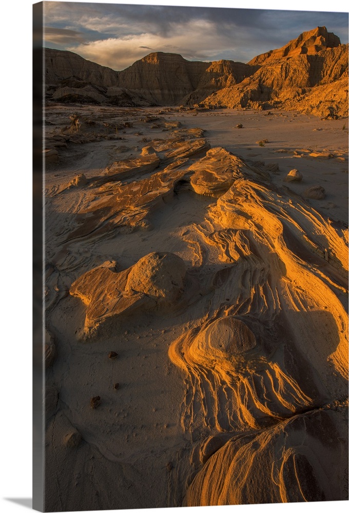 Eroded rocks in the South Dakota Badlands in warm light from the sunset.