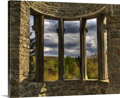 A bay window set in stoone walls overlooking the countryside