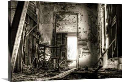 A derelict interior with peeling plaster and broken walls