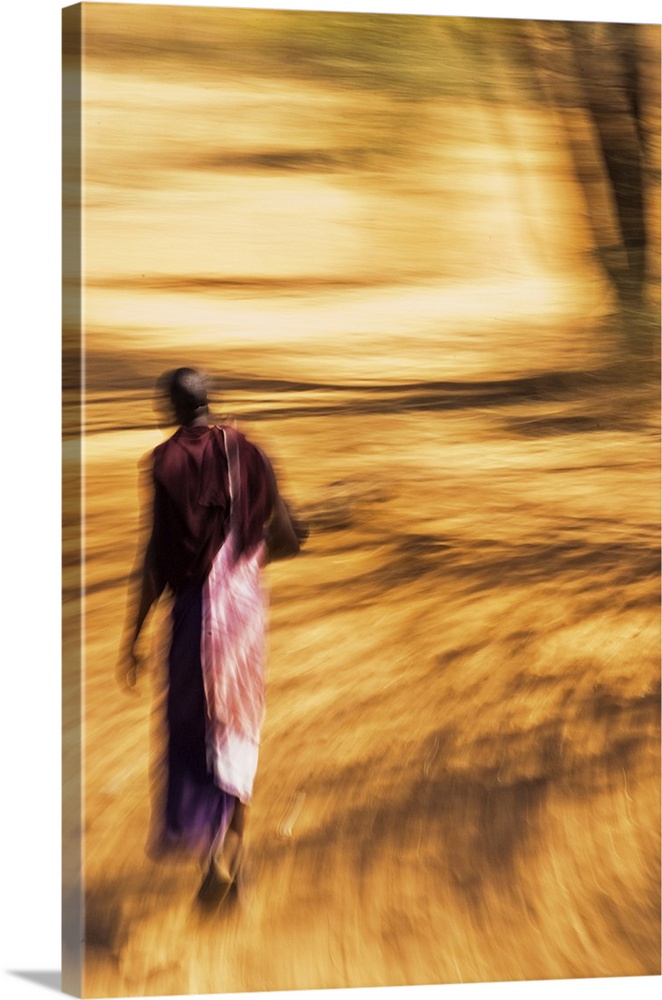 An African Masai tribesman walking with motion blur