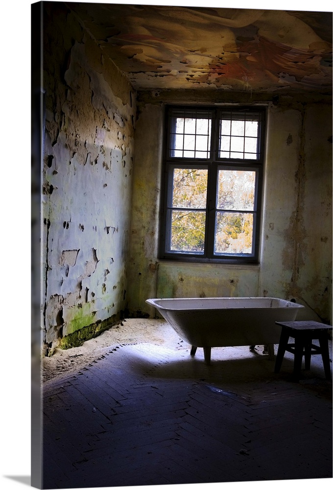 Old bathroom with stool in derelict room near window