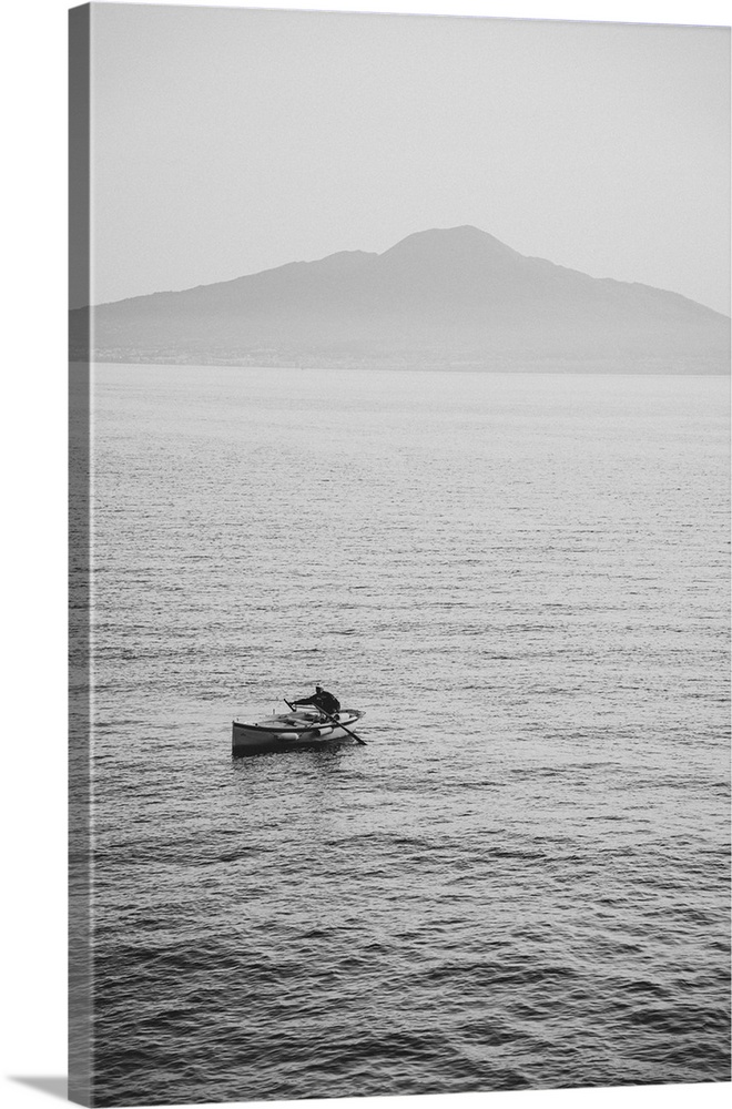 Fisherman from Sorrento, Italy in a small rowing boat with Mount Vesuvius in the background.