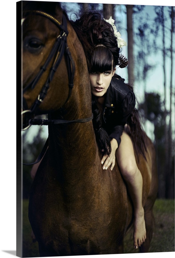 Young woman with black hair sitting bare back on horse leaning forward towards the camera