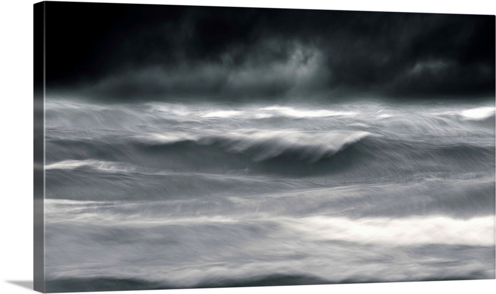 Powerful waves in a seascape under a dark stormy sky