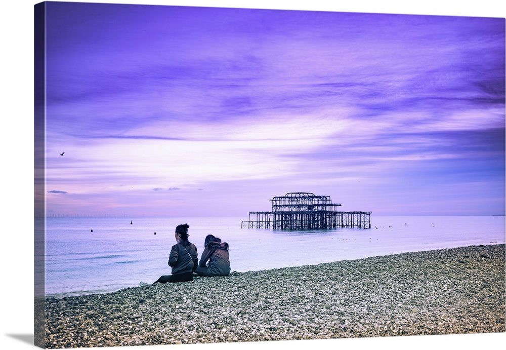 Brighton is a seaside town in the south of England, UK. Dusk on the beach. The West Pier is a pier in Brighton, England. I...