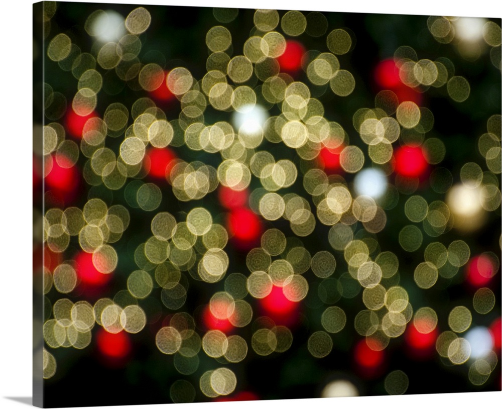 A blur of bokeh lights in red and white in the city at Christmastime.