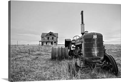 Derelict farm machinery with house in Pierce County, USA