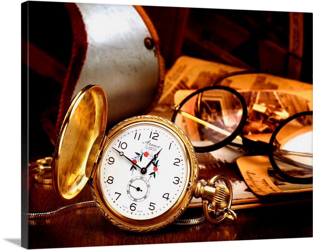 A pocket watch and glasses