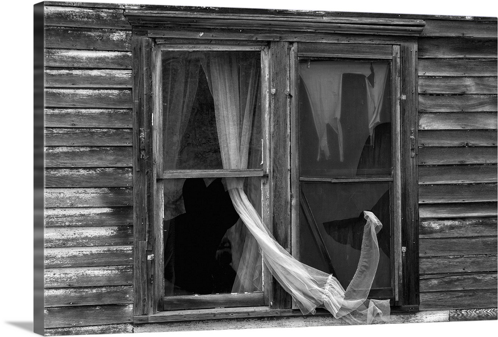 Abandoned house with curtain in broken window in Berwick, McHenry County USA