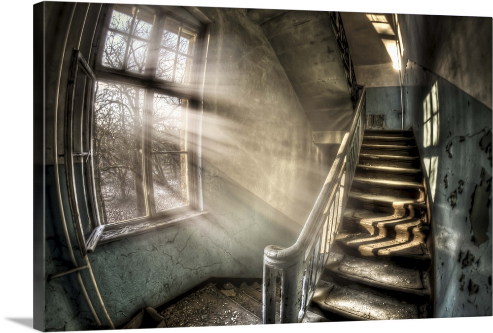 Abandoned lunatic asylum north of Berlin, Germany. Stairwell with sunlight in window.