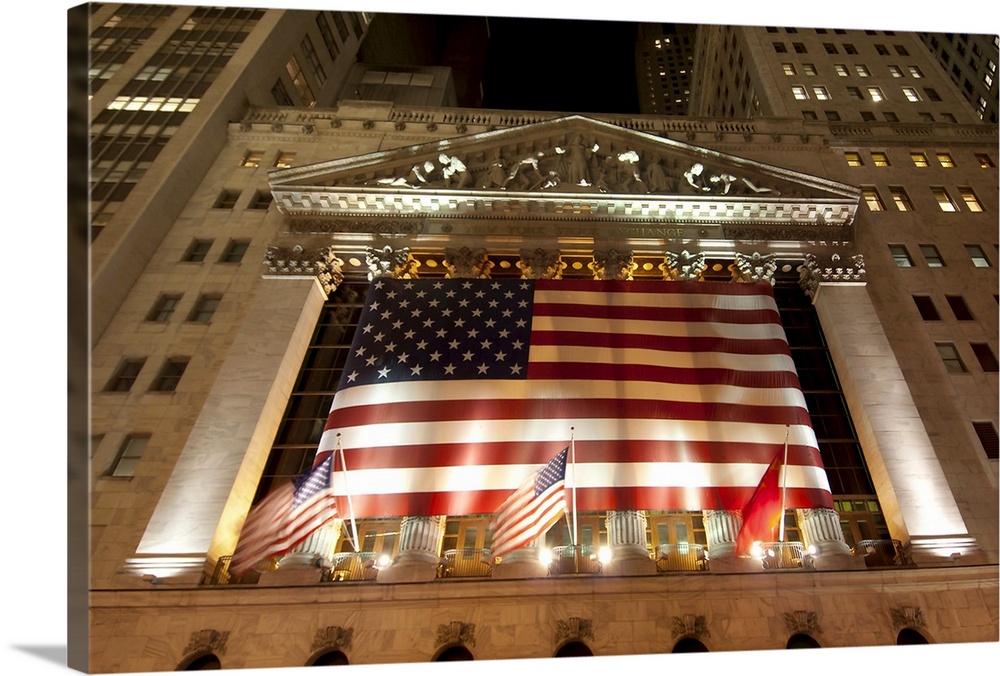 Low angle shot of New York's Stock Exchange on Wall Street at night.