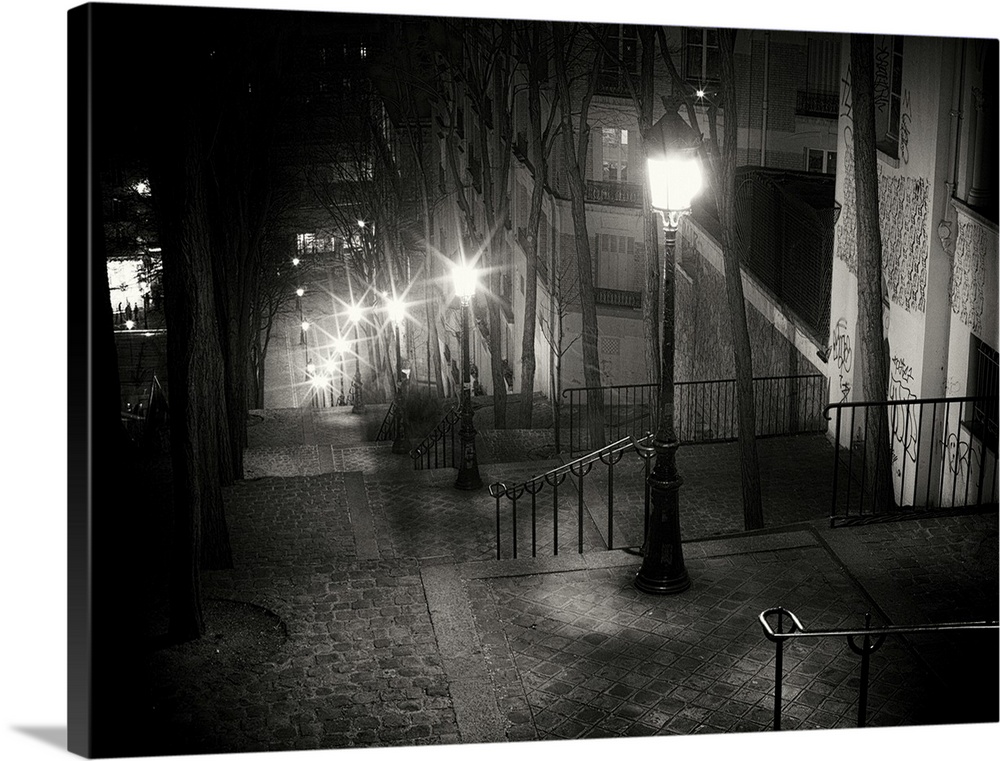 Steps on Parisian street at night with glowing street lamps