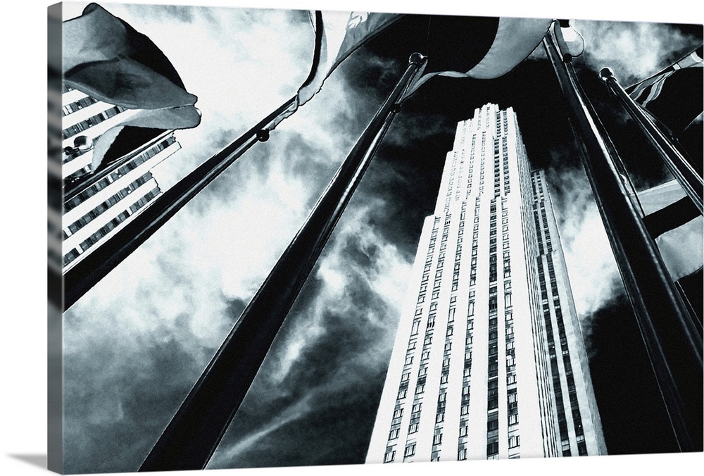 Dramatic black and white of Rockefeller Center from a low angle.