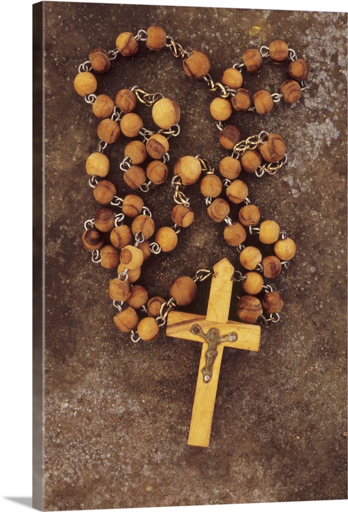 Rosary with crucifix lying on tarnished metal