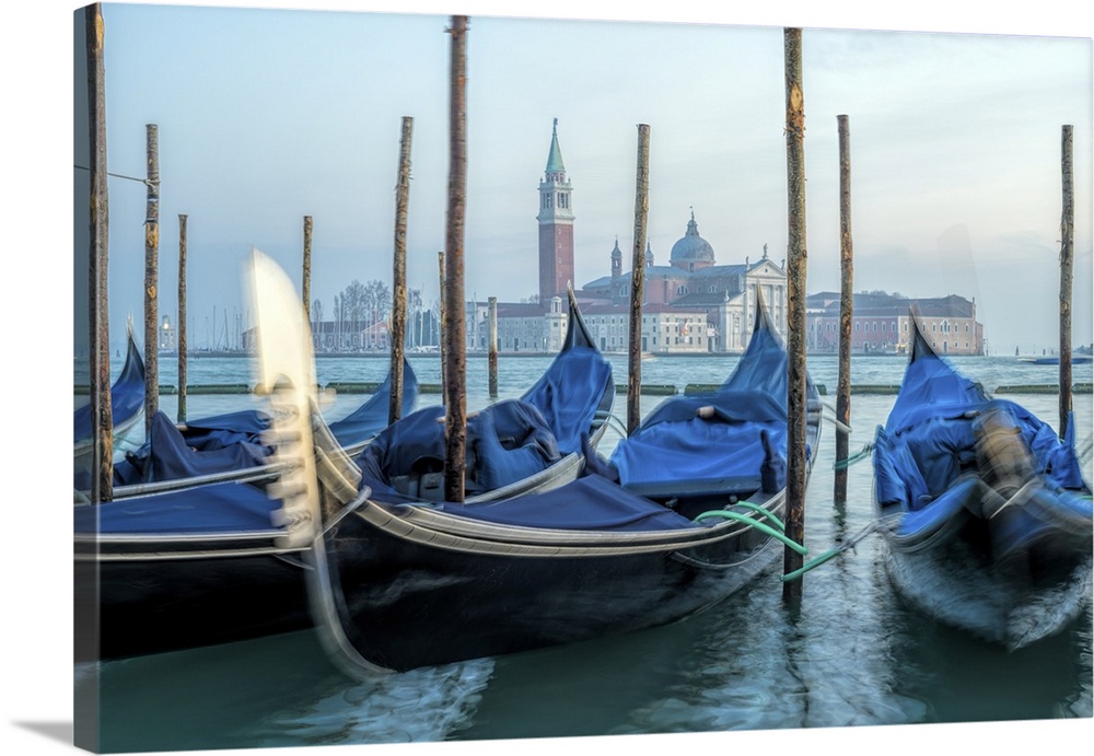 Moored gondolas with San Giorgio Maggiore in the background at Riva degli Schiavoni, Venice, Italy.