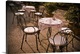 image thumbnail of Tables are set at an outdoor bistro in Italy