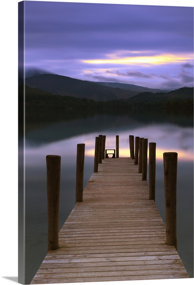 Jetty at twilight in the Lake District with calm water under a sunset