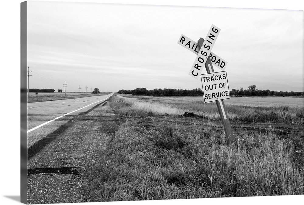 Road sign by disused railroad in Bottineau County USA
