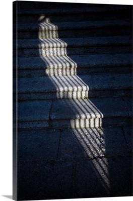 The shadow of a window grille on stone steps, Caceres, Spain