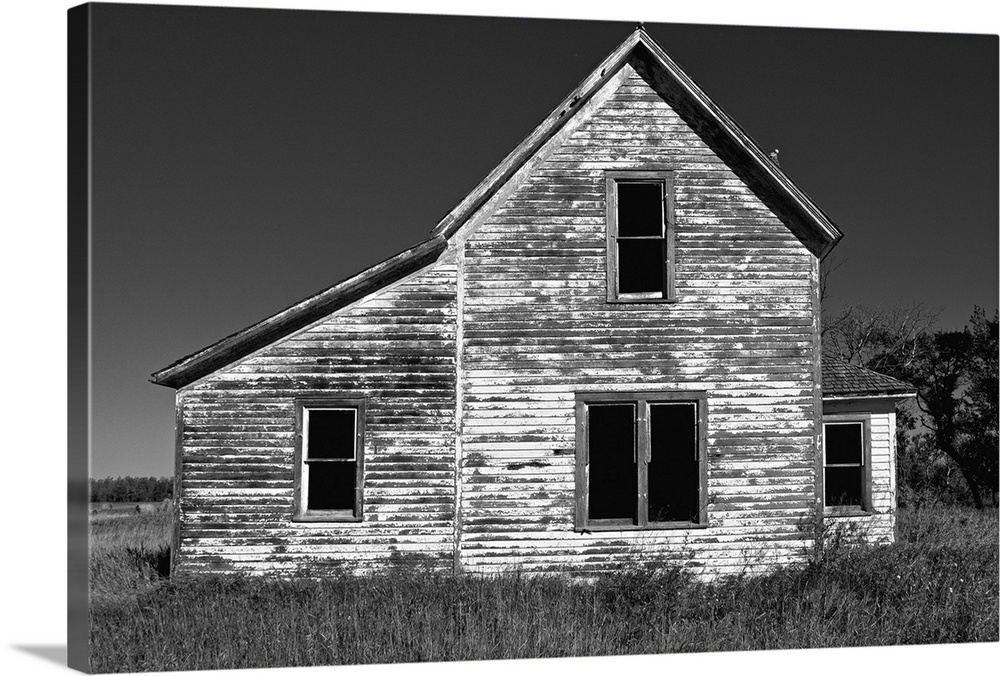 Abandoned timber home in rural location under summer skies in Eddy County USA