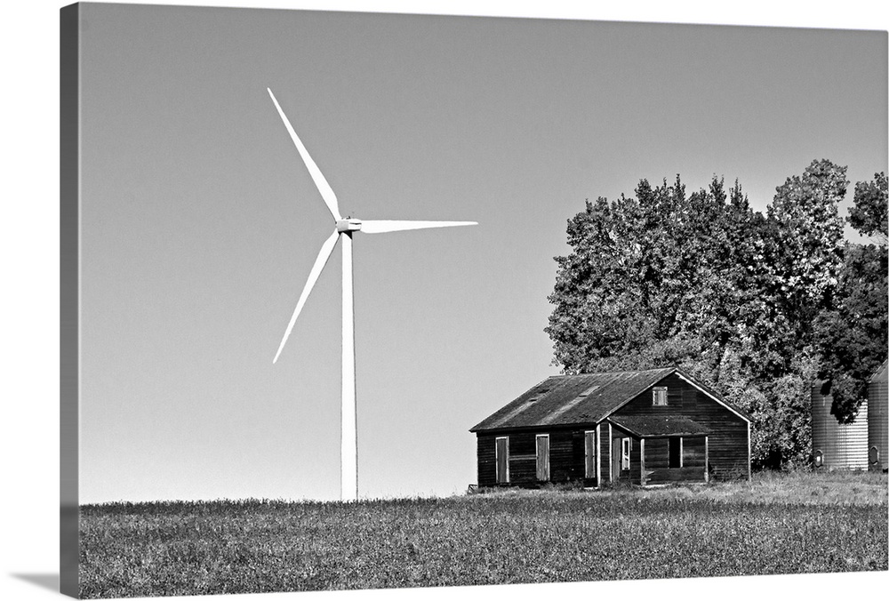 Wind turbine in rural location with old barn in Cavalier County USA