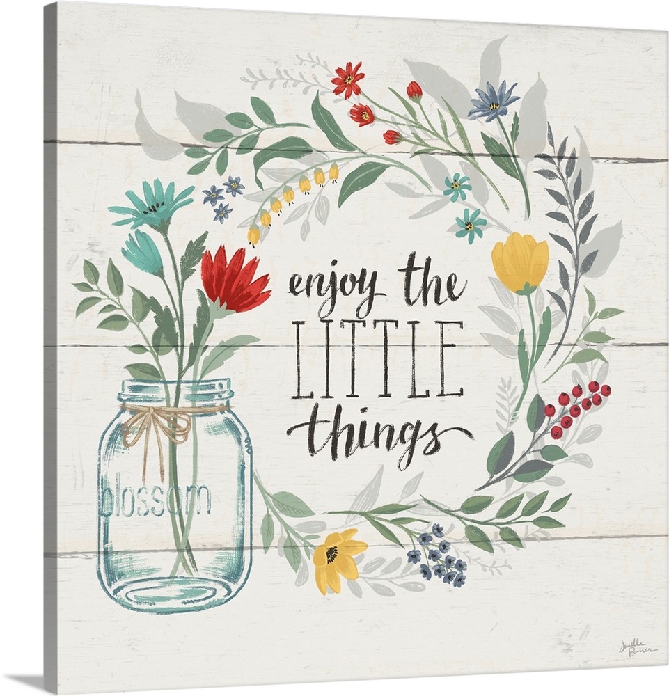 "Enjoy the Little Things" written inside a floral wreath on a white wood paneled background.