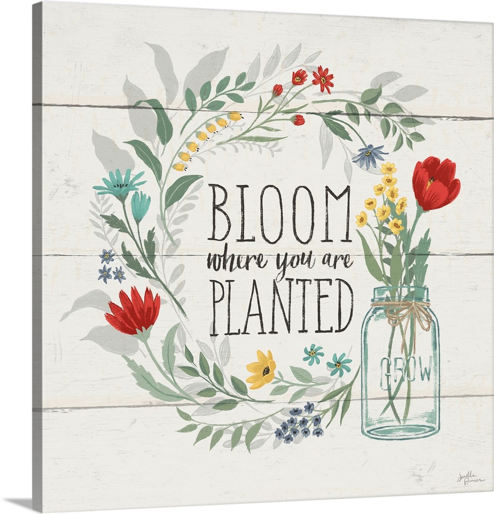 "Bloom Where You Are Planted" written inside a floral wreath on a white wood paneled background.