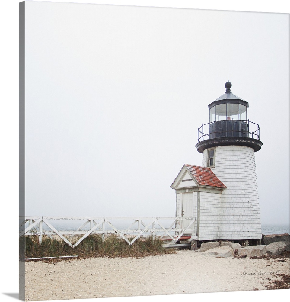A square photograph of the Brant Point Lighthouse in Nantucket Island, Massachusetts, blanketed in a light fog.