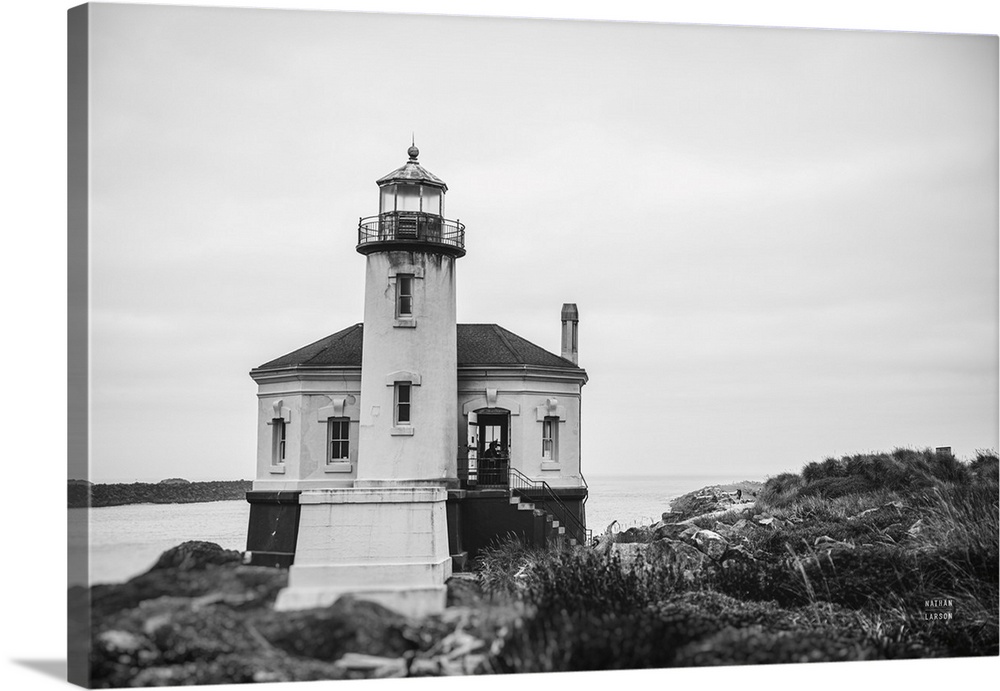 Captured in the timeless elegance of black and white, this fine art print presents a historic lighthouse standing vigil on...